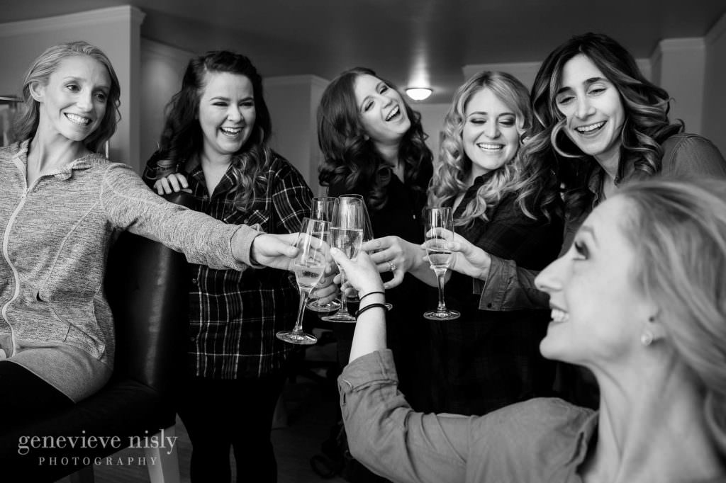 Brides gives a toast with her bridesmaids while getting ready for her wedding at the Ritz Carlton in Cleveland.