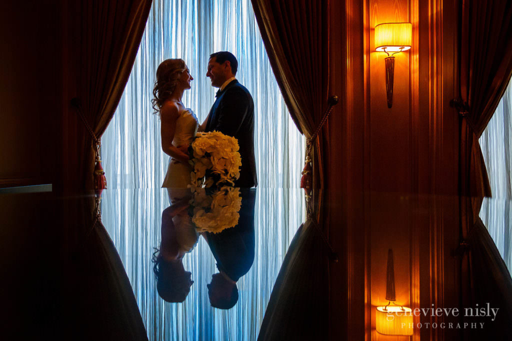 Bride and groom framed in front of a window at the Ritz Carlton in Cleveland.