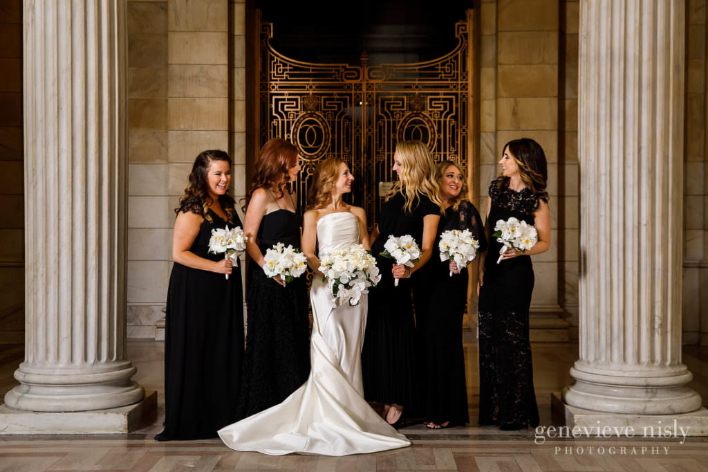 Bridesmaids in front of an iron grated door.