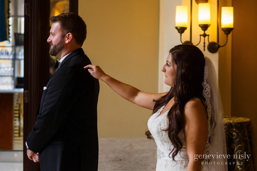 Bride taps groom on his should during their first look at their wedding at Onesto Lofts.
