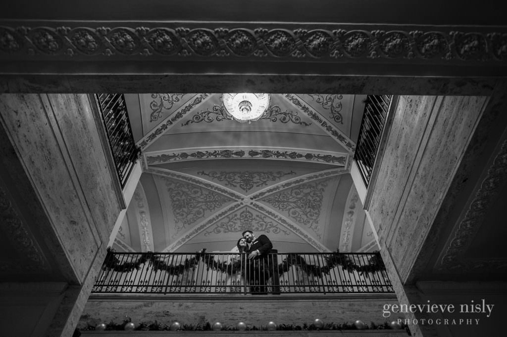 Bride and groom in the grand staircase at their Onesto Lofts wedding.