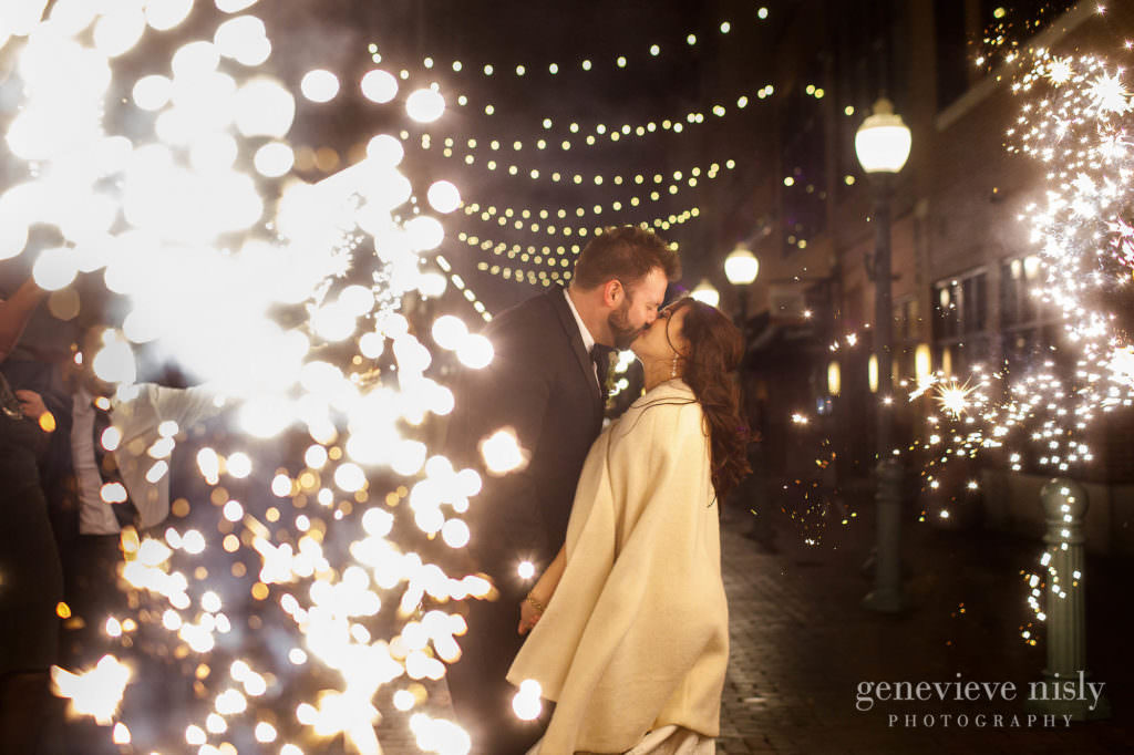 Bride and groom kiss during their sparkler exit.