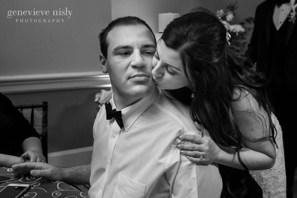 Bride kisses her brother on the cheek during the wedding reception.