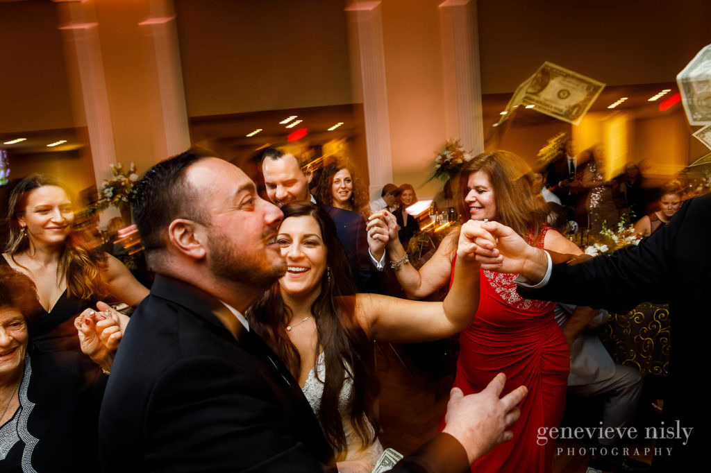 Guests dance at party on the dance floor during the reception.