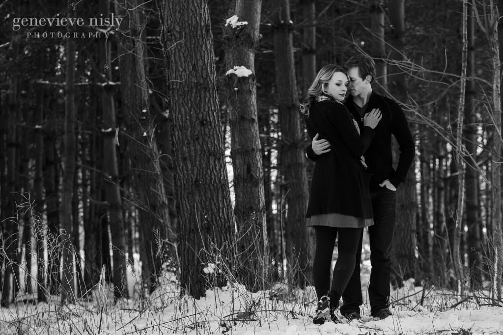 Michael and Jacee in front of evergreens during their winter engagement  session.