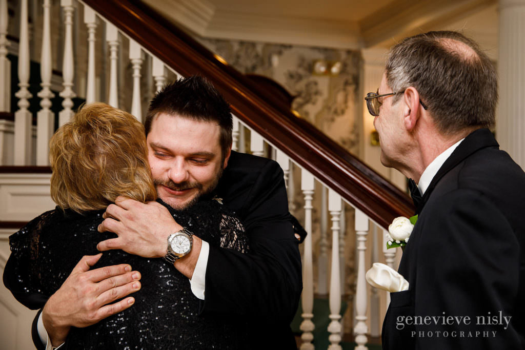The groom hugs his parents before walking down the aisle at Mooreland Mansion.