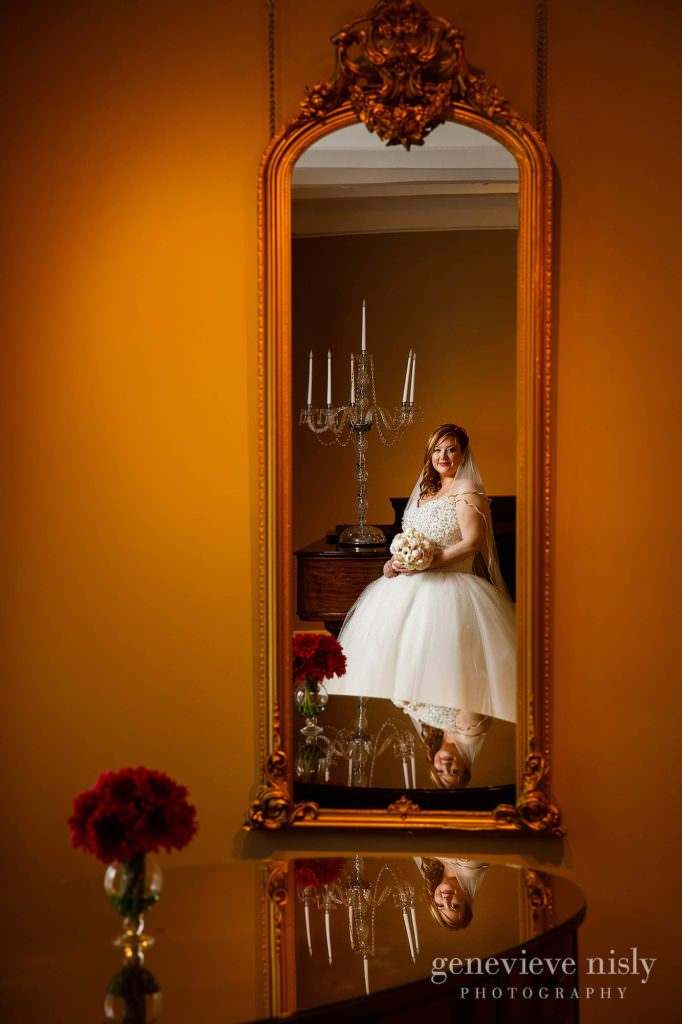 The beautiful bride is admiring her reflection at Mooreland Mansion.