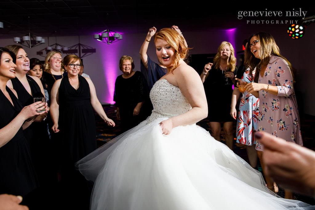 The bride is twirling on the packed dance floor of her wedding at the Cleveland Holiday Inn.