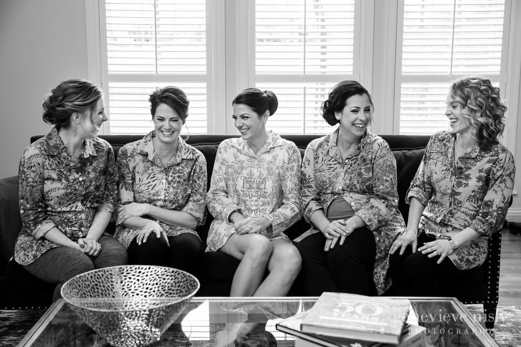 A bride and her bridesmaids share a laugh.
