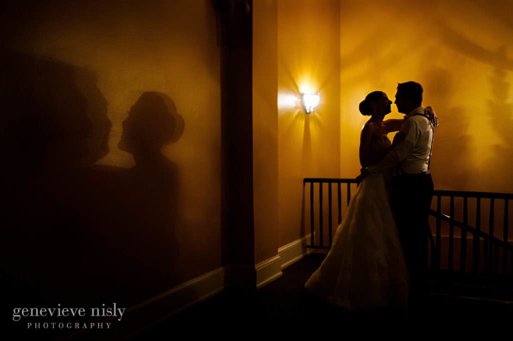 Bride and groom cast a shadow on the wall at their reception.