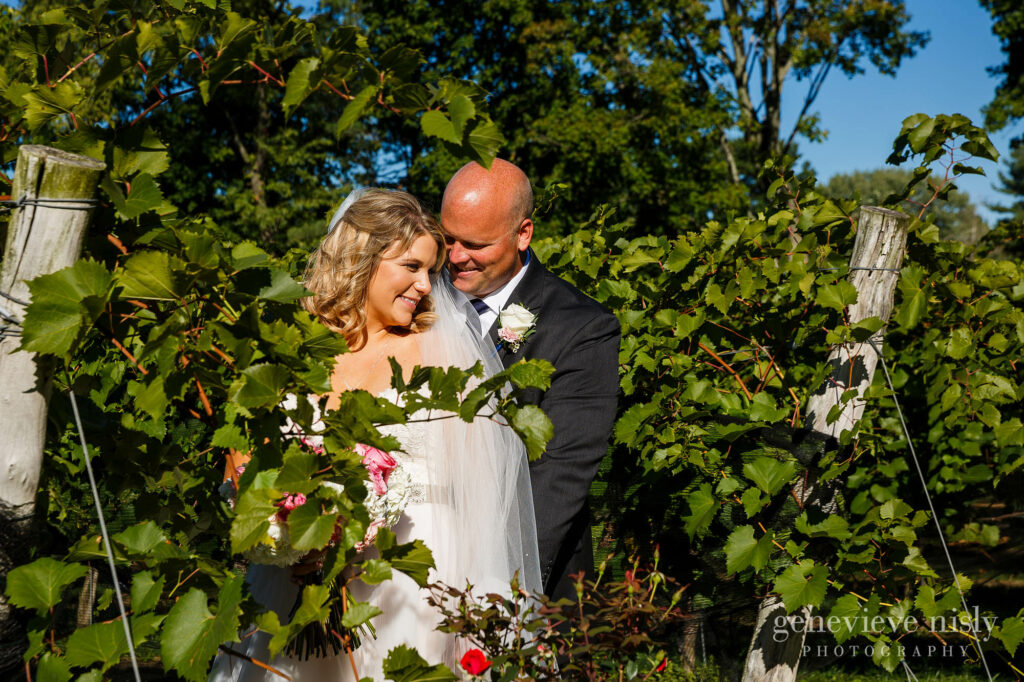 Bride and groom surrounded by vines during a wedding at Gervasi Vineyard in Canton, Ohio by Cleveland wedding photographers Genevieve Nisly Photography.