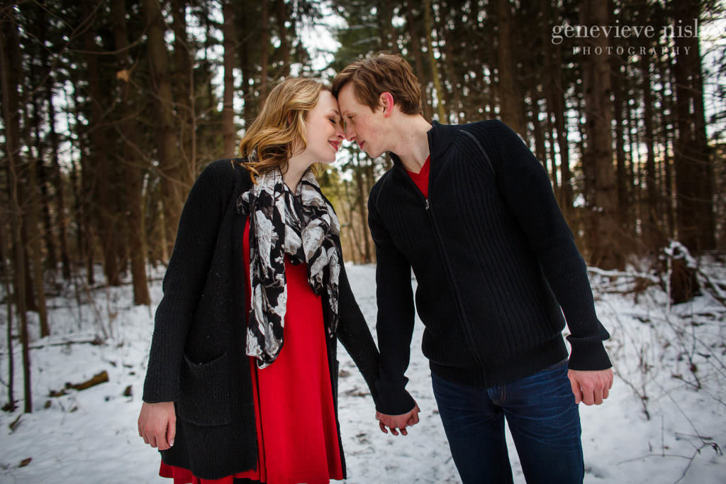 Jacee in a bright red dress during their engagement session.