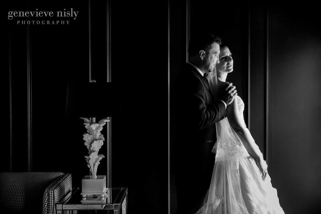 Window lit black and white of the bride and groom on their wedding day.