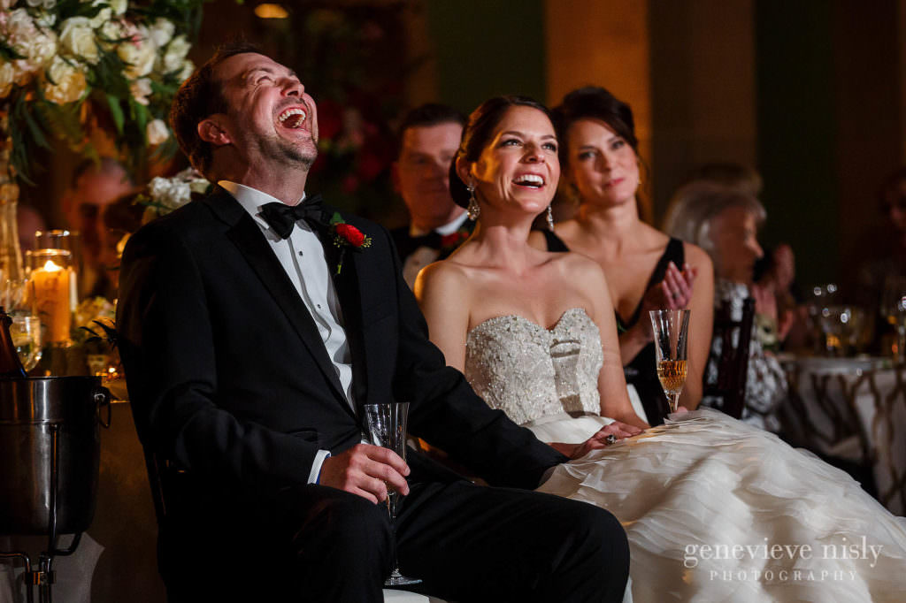 Bride and groom laugh during the best man's toast.