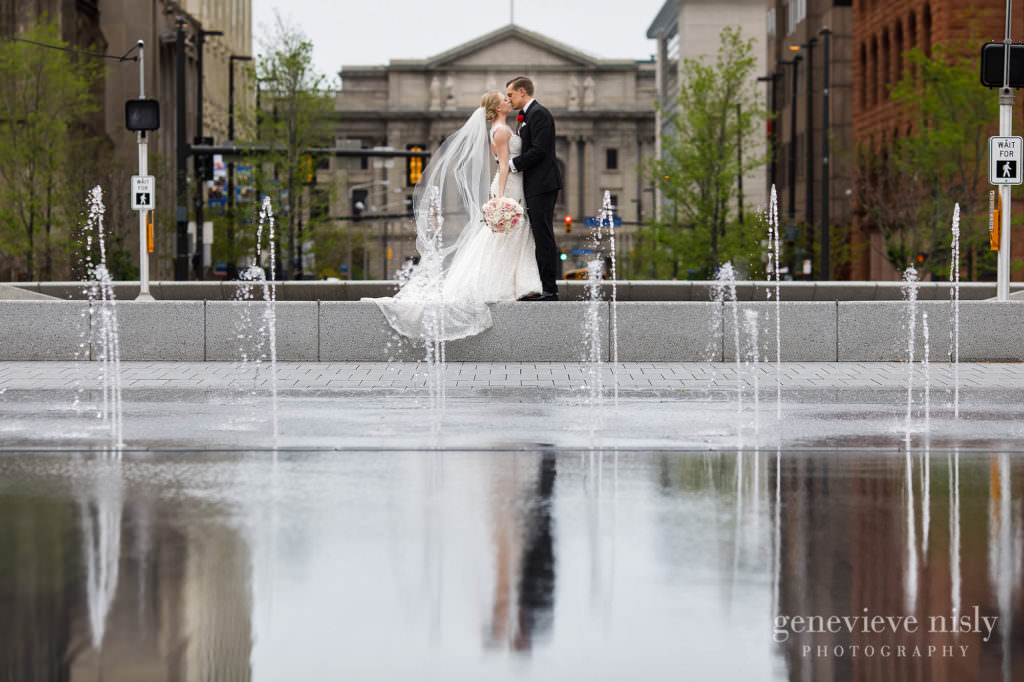 Brittany and Travis reflected in the splash pool in Downtown Cleveland's Public Square on their wedding day.
