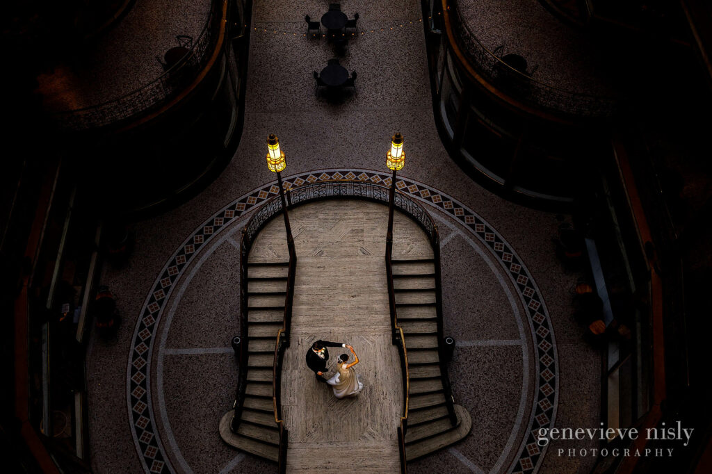Natalya and Cameron dance on the grand staircase during their wedding at the Hyatt Arcade in Downton Cleveland, Ohio.