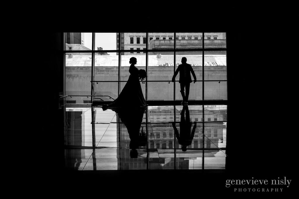 Justin and Kate in silhouetted against the windows of the Westin during their wedding in Downtown Cleveland.