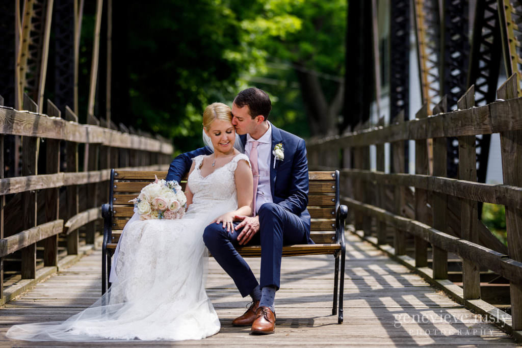 Annie and Luke snuggle each other on the bridge across the street during their Chagrin Valley Hunt Club Wedding in Cleveland Ohio.