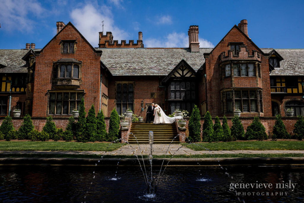 Laura and Anthony on the west terrace of Stan Hywet Hall and Gardens during their wedding in Akron, Ohio. Photo by Genevieve Nisly Photography.