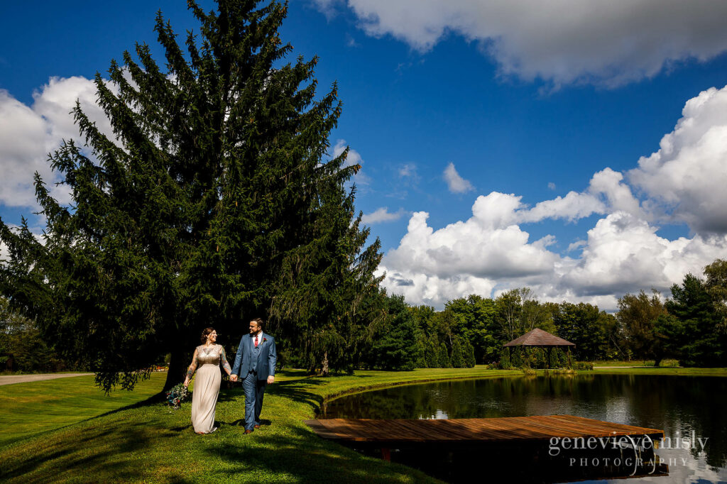 Chris and Nicole take a walk near the lake during the Meadow Ridge Farm wedding in Cleveland, Ohio.