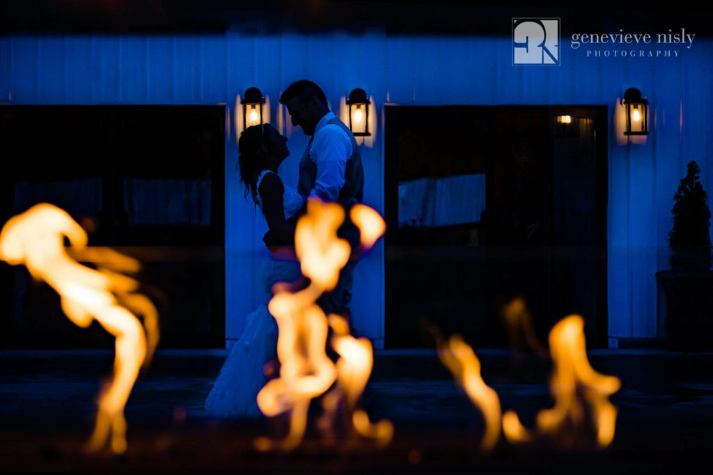 Richard and Amanda by the outdoor fireplace on their wedding day at the Rustic Ridge Wedding Barn in New Philadelphia, Ohio.