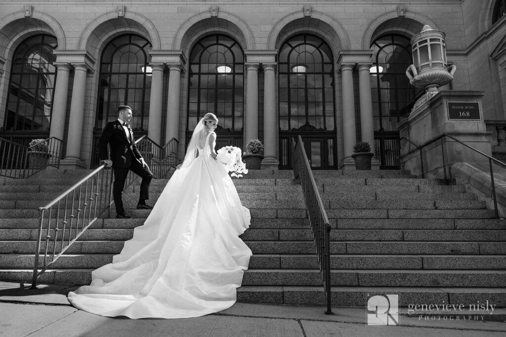 Bride and groom on a grand staircase in Akron, Ohio on their wedding day. Shot by Genevieve Nisly Photography.